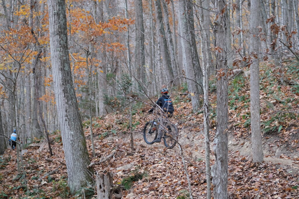 Mountain Bikers Ride through fall leaves on Monday Lick Trail