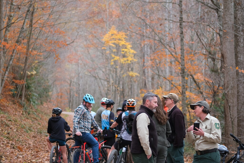 Stakeholders, USDA employees, and mountain biker riders meet at the Monday Lick Trailhead