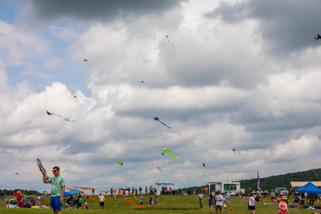 Dozens of colorful kites fly in the sky above Spruce Knob