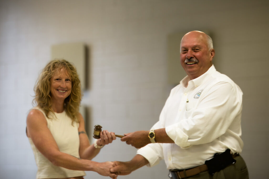 Sam Felton of Marlinton passes the Partnership Board Chair torch to Elkins Representative Jessica Sutton