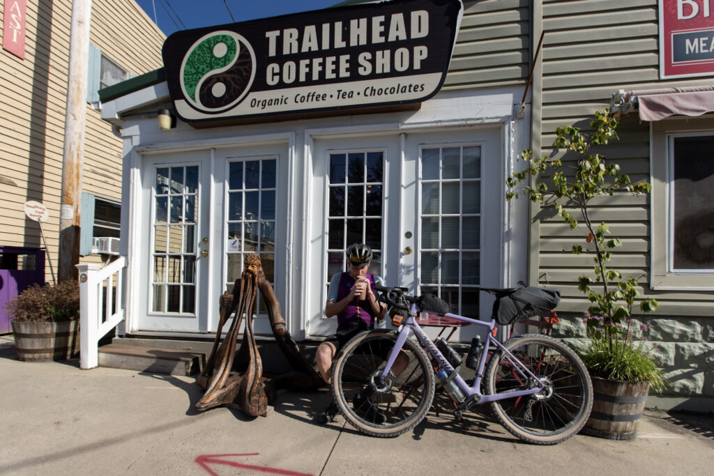 Man on gravel bikpacking trip stops at coffee shop in Davis, West Virginia